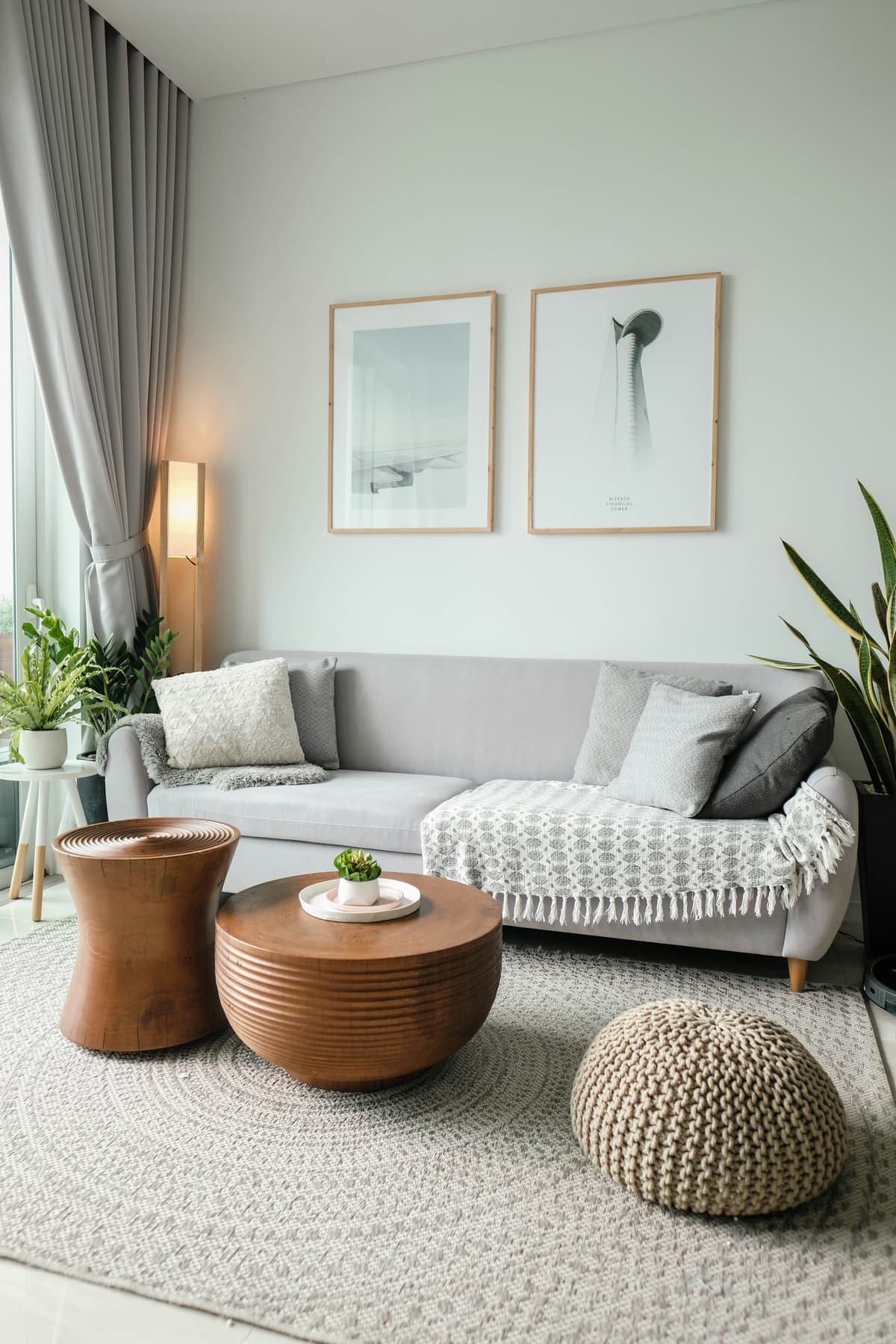 Living room with soft grey painted walls, framed prints and a cosy sofa